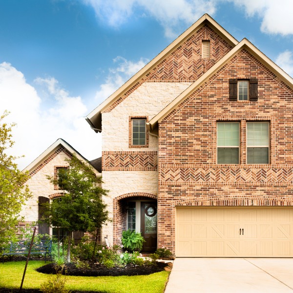 Website-Windmere-section-house-bricks-garden Large brick home with unique architectural patterns and professionally landscaped front yard.